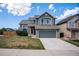 Charming two-story home featuring a well-maintained lawn, a stone-accented facade, and an attached two-car garage at 5479 Lost Meadow Trl, Castle Rock, CO 80104