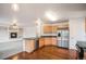 Bright kitchen features stainless steel appliances, wood cabinets, and hardwood floors at 5479 Lost Meadow Trl, Castle Rock, CO 80104