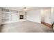 Spacious living room with fireplace, custom built-ins, and neutral carpet at 5479 Lost Meadow Trl, Castle Rock, CO 80104