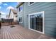 Exterior view of wood patio with sliding glass door leading inside and black metal railing at 5479 Lost Meadow Trl, Castle Rock, CO 80104