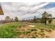 Large grassy backyard area with a metal frame near the edge of the property line at 19855 Draco Dr, Monument, CO 80132