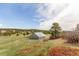 Wide-open backyard featuring a spacious field and large barn, perfect for outdoor activities at 19855 Draco Dr, Monument, CO 80132