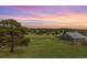 Picturesque backyard with a lush green field and outbuilding at 19855 Draco Dr, Monument, CO 80132