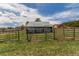 The exterior of a barn with black pipe fencing in a grassy field on a sprawling lot at 19855 Draco Dr, Monument, CO 80132