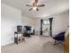 Bedroom with a ceiling fan, carpeted floors, and a work station with a window and dark curtains at 19855 Draco Dr, Monument, CO 80132
