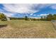 View of land showcasing a large grassy area with barn, trees and blue sky above at 19855 Draco Dr, Monument, CO 80132