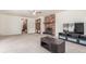 Spacious living room with a cozy brick fireplace, ceiling fan, and ample space for entertaining guests at 19855 Draco Dr, Monument, CO 80132