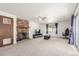 Inviting living room featuring a brick fireplace, ceiling fan, and sliding glass doors for ample natural light at 19855 Draco Dr, Monument, CO 80132
