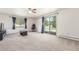 Bright living room with a ceiling fan, large windows with views, and sliding glass doors to bring the outdoors in at 19855 Draco Dr, Monument, CO 80132