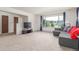 Bright living room featuring neutral tones, large windows, and a comfortable sofa, perfect for relaxation at 19855 Draco Dr, Monument, CO 80132