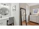 Bright bathroom with a round mirror and light fixtures, complemented by neutral paint and flooring at 2355 E Geddes Ave # C24, Littleton, CO 80122