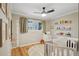 Cozy bedroom featuring light-colored walls, a crib, and a wall ruler for tracking growth at 2355 E Geddes Ave # C24, Littleton, CO 80122
