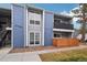 Exterior of blue townhouse with well-maintained lawn, showcasing a modern design and a cozy balcony at 2355 E Geddes Ave # C24, Littleton, CO 80122