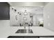 Bright kitchen with stainless steel faucet and view into the adjacent dining area at 2355 E Geddes Ave # C24, Littleton, CO 80122