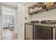 Functional laundry area with modern washer and dryer set, next to a bedroom at 2355 E Geddes Ave # C24, Littleton, CO 80122