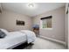 Neutral finished basement bedroom with a full sized bed and egress window at 3059 Morningbird Ln, Castle Rock, CO 80109