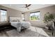 Bright bedroom with a large window, a cozy rug, and stylish furniture at 3059 Morningbird Ln, Castle Rock, CO 80109