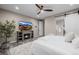 Bedroom with fireplace, TV, ceiling fan, and barn door to bathroom at 3059 Morningbird Ln, Castle Rock, CO 80109