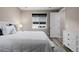 Well-lit bedroom with a comfortable bed, white furniture, modern window, and neutral decor, promoting rest and relaxation at 3059 Morningbird Ln, Castle Rock, CO 80109