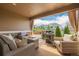 Inviting covered patio featuring wicker furniture, a cozy fire pit, and an outdoor grill at 3059 Morningbird Ln, Castle Rock, CO 80109