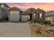 Charming home with a two-car garage, stone accents, and well-maintained landscaping at 3059 Morningbird Ln, Castle Rock, CO 80109