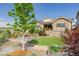 Landscaped front yard features metal planter boxes and a small artificial lawn at 3059 Morningbird Ln, Castle Rock, CO 80109