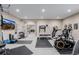 This home gym comes equipped with a variety of machines and weights for working out at 3059 Morningbird Ln, Castle Rock, CO 80109