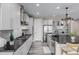 Modern kitchen features white cabinets, stainless steel appliances, black counters, and a stylish island with pendant lighting at 3059 Morningbird Ln, Castle Rock, CO 80109
