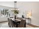 Elegant dining room featuring a contemporary chandelier and plenty of natural light from the large window at 7883 Fox Creek Trl, Franktown, CO 80116
