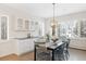 Bright dining room boasts natural light, lovely built-ins, and stylish modern lighting at 7883 Fox Creek Trl, Franktown, CO 80116
