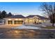 Beautiful home with white exterior, dark roof, and a spacious three-car garage at dusk at 7883 Fox Creek Trl, Franktown, CO 80116