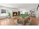 Spacious game room features a pool table, fireplace with stone surround, and tile flooring at 7883 Fox Creek Trl, Franktown, CO 80116
