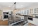 Gourmet kitchen boasts granite counters, stainless steel appliances, a large island and modern fixtures at 7883 Fox Creek Trl, Franktown, CO 80116