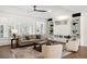 Bright living room with a built-in bookcase, plush furniture, and natural light with a view to the balcony at 7883 Fox Creek Trl, Franktown, CO 80116