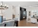 Spacious living room seamlessly connects to the dining area and features a fireplace and a view to the balcony at 7883 Fox Creek Trl, Franktown, CO 80116