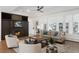 Cozy living room with a fireplace and black built-in, plush furniture, and a large window to the outdoors at 7883 Fox Creek Trl, Franktown, CO 80116