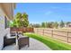 Relaxing backyard patio with comfortable seating and a view of the fenced yard and surrounding greenery at 7472 S Memphis St, Aurora, CO 80016
