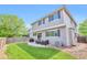 Spacious backyard with a patio, lush lawn, and privacy fence, perfect for outdoor entertaining at 7472 S Memphis St, Aurora, CO 80016