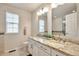 Bright bathroom with double sinks, granite countertop, and large mirrors at 7472 S Memphis St, Aurora, CO 80016