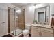 Bathroom featuring a glass-enclosed shower and granite-topped vanity at 7472 S Memphis St, Aurora, CO 80016