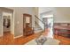 Welcoming foyer with hardwood floors, a staircase, and a decorative mirror, leading to the main living areas at 7472 S Memphis St, Aurora, CO 80016