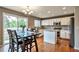 Modern kitchen with white cabinets, stainless steel appliances, and a center island, perfect for cooking and entertaining at 7472 S Memphis St, Aurora, CO 80016