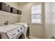 Bright laundry room featuring side-by-side Samsung washer and dryer at 7472 S Memphis St, Aurora, CO 80016