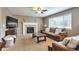 Cozy living room featuring a fireplace, plush sofa, and lots of natural light at 7472 S Memphis St, Aurora, CO 80016