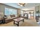 Bright living room connected to the kitchen, featuring comfortable seating at 7472 S Memphis St, Aurora, CO 80016