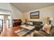 Inviting living room with hardwood floors, vaulted ceilings, and stylish decor, creating a comfortable and elegant space at 7472 S Memphis St, Aurora, CO 80016