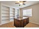 Dedicated office space with custom built-in bookshelves and a large executive desk at 7472 S Memphis St, Aurora, CO 80016