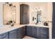 Bathroom with double sinks, dark cabinets, large mirrors and modern lighting at 7837 Inverness Blvd, Englewood, CO 80112