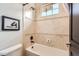 Bright bathroom featuring a tile shower/tub combination and framed art at 7837 Inverness Blvd, Englewood, CO 80112