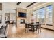 Open dining room with hardwood floors, a fireplace, and large windows at 7837 Inverness Blvd, Englewood, CO 80112